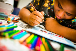 A person draws a colourful picture.