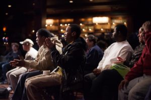 An audience claps at a Live Connections concert.