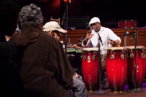 A man plays a set of drums during a Live Connections concert.