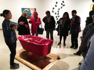 Art-Reach staff member Angela Wang audio describes a pink bedazzled bath tub.