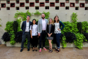 Staff photo in front of garden