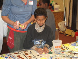 Boy from Overbrook School for the Blind making mosaic with teacher