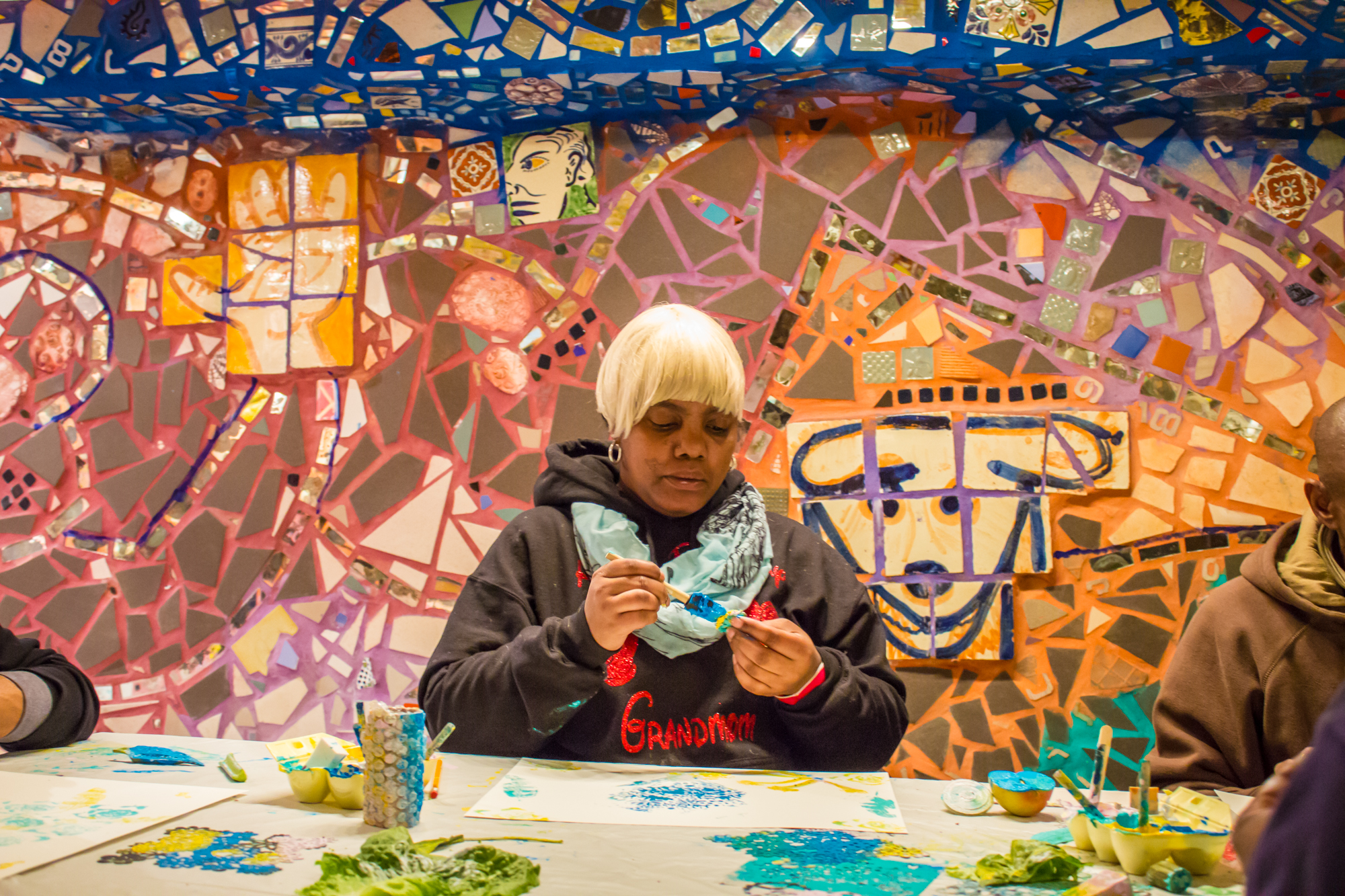 A woman creates artwork at Philadelphia's Magic Gardens