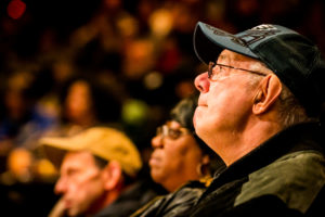 A man looks attentively from an audience.