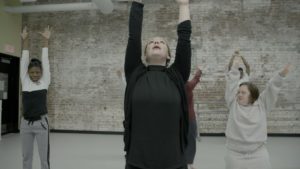 PA ballet dancers and students from Saint Katherine Day School stretch their arms over their heads.