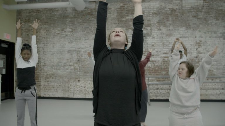 PA ballet dancers and students from Saint Katherine Day School stretch their arms over their heads.