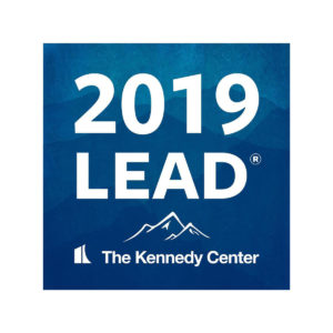 Navy Blue LEAD logo reads: 2019 LEAD, The Kennedy Center with white capped mountains illustrated above "the Kennedy Center