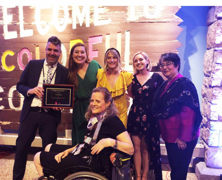 The Art-Reach Staff poses with Betty Siegel, the Director of the Office of VSA & Accessibility, and our Community Asset Award. We are smiling SO HARD !