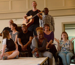 Mixed ability staff from A fierce kind of love production singing together