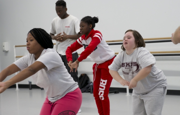 disabled adolescents and dance students learning ballet in a dance studio