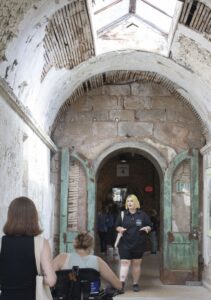 Art-Reach staff listening to a tour at a historic penitentiary